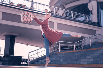 Wonderful mood. Joyful positive ballerina dancing from happiness after doing shopping © Viacheslav Yakobchuk