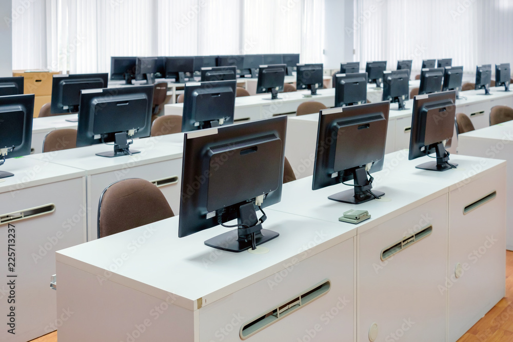 Poster classroom computers. empty no people with many monitor computer on white desk.