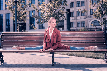 My talent. Positive skilled dancer sitting on the bench while doing the splits in the park © Viacheslav Yakobchuk