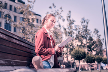 Pleasant relaxation. Nice happy dancer sitting on the bench while doing the splits © Viacheslav Yakobchuk