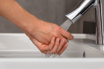 Woman washing her hands with water