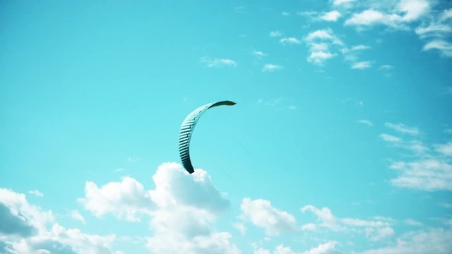 Extreme kite boarding in slow motion. Summer fun action sports. Kiteboarding at sunrise in slow motion, active lifestyle extreme sport.