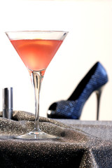 Cosmopolitan cocktail with lipstic and high heel shoe