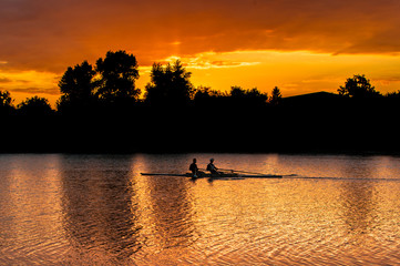 Naklejka na ściany i meble kayaks in the rays of the setting sun
