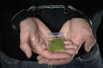 police detention drug courier. close up of addict narcotics dose marijuana handcuffs. arrested drug...