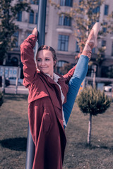 In the park. Joyful nice woman standing near the lantern while dancing there © Viacheslav Yakobchuk