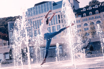 Beautiful dance. Beautiful graceful woman jumping up while dancing in the fountain © Viacheslav Yakobchuk