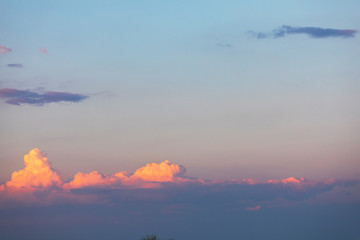 Beautiful sunset sky with volumetric clouds. Overflowing colors from dark blue to bright orange