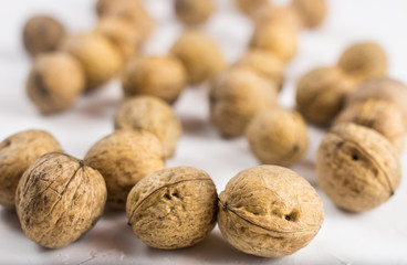 Walnuts on white textured surface. Close up.