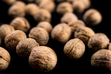 Walnuts on black background. Close up.