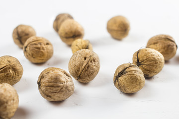Walnuts on white textured surface. Close up.