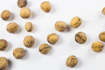 Walnuts on white textured surface. Close up.