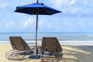 Relaxing or Leisure beach chairs with umbrella on the sand with blue sky and cloud.