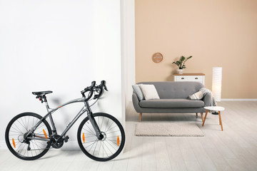 Modern apartment interior with bicycle near wall. Space for text