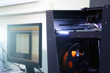 3D laser printer. Print parts on a 3D printer with a plastic figure .