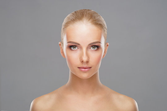 Beautiful face of young and healthy girl. Skin care, cosmetics and face lifting concept.