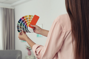 Female interior designer with color palette samples indoors