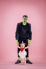 Halloween Family. Happy Father and Children Newborn Girl in Halloween Costume and Makeup. Bloody...