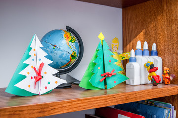corner of children's creativity, fabrication for  Christmas holiday, Christmas trees decorated with toys