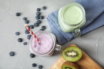 Flat lay composition with delicious milk shakes on grey background