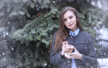 Young girl outdoors in winter. Model girl posing outdoors on a w