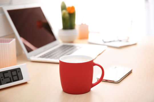 Red Cup With Coffee And Phone Near Laptop On Office Table. Break Time