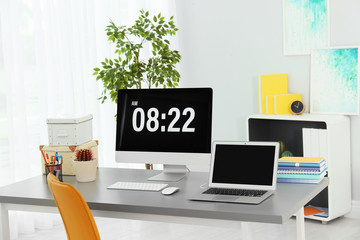 Stylish workplace with laptop and desktop computer on table