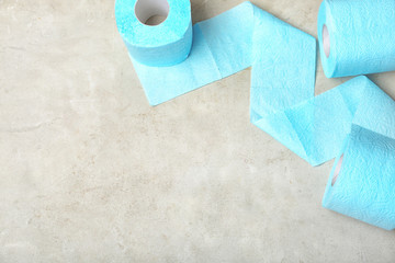 Toilet paper rolls on grey background, top view. Space for text