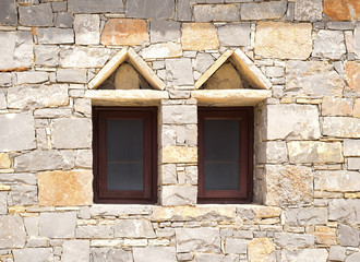 Two windows in a brick wall