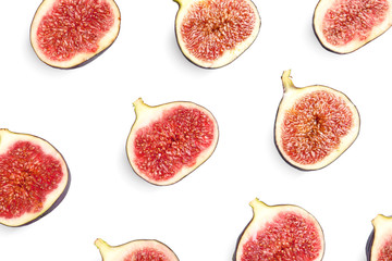Cut ripe figs on white background, top view