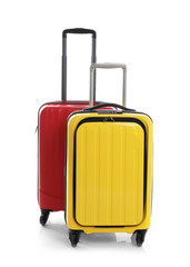 Modern suitcases for travelling on white background