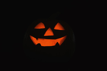 Halloween pumpkin head. Glowing jack lantern in dark