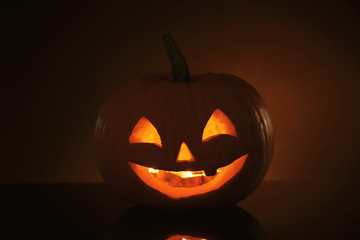 Halloween pumpkin head. Glowing jack lantern in dark