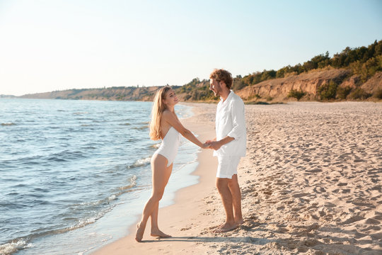 Romantic young couple spending time together on beach