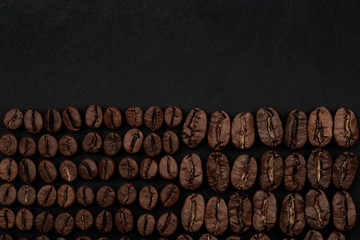 Roasted coffee beans on black background