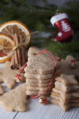 Ginger biscuits and Christmas decorations against a background of spruce branches