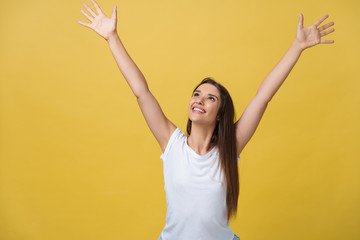 Young beautiful happy girl portrait isolated on yellow background.