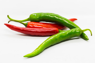 red and green chili peppers isolated on white background
