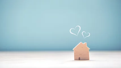Foto op Canvas Home sweet home, house wood with heart shape on wooden and blue background, copy space. © oatawa