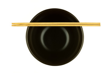 bamboo chopsticks on brown ceramic bowl isolated on white background.