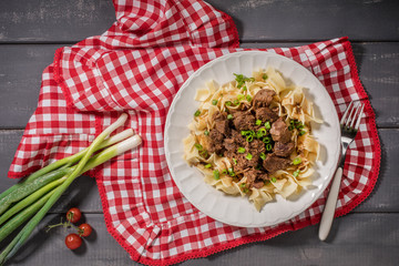 Stewed beef with tagliatelle pasta.