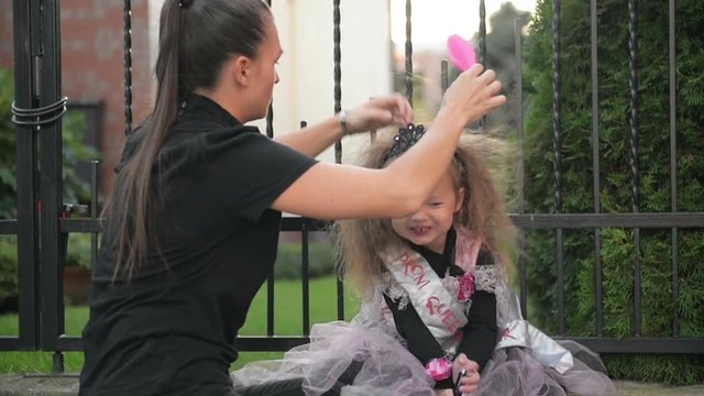 Woman Preparing Her Daughter To Halloween. Young Cutie Girl Having Fun. Happy Halloween