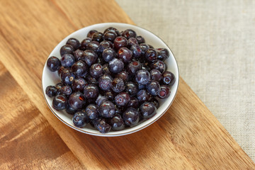 Frozen forest blueberries thawed in a small saucer