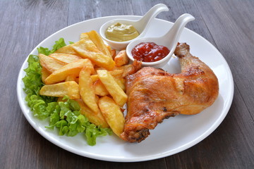 udko kurczaka pieczone z frytkami, ketchupem i musztardą