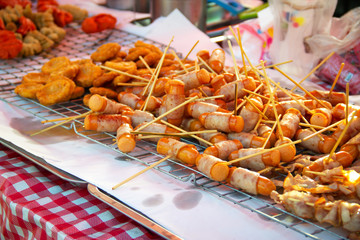 Fried hotdog with ham wrap around. Junk food. Street food.