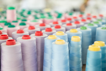 a lot of colorful coils of sewing threads, close-up