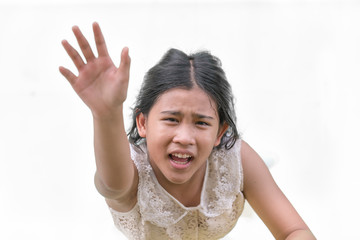 The little girl looked up at the sky and raised her hand for help.
