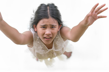 The little girl looked up at the sky and raised her hand for help.
