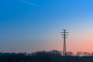 silhouette of high voltage electric tower with beautiful sky background