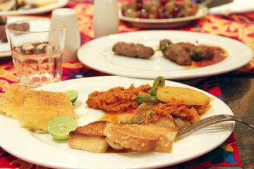 Dish of grilled toast, vegetables and lime. Dinner in restaurant